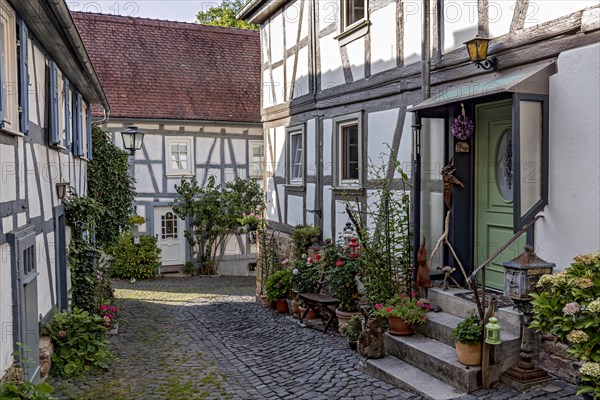 Old half-timbered houses, decorated with flowers, idyllic alley, old town, Ortenberg, Vogelsberg,