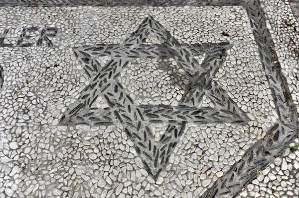 Solabrena, Creative star mosaic design embedded in a pebble pavement, Costa del Sol, Andalusia,