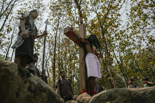 Christian devotees takes part in a perform to re-enactment of the crucifixion of Jesus Christ