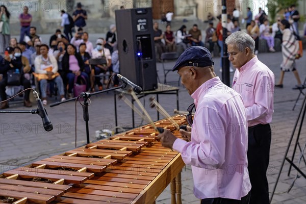 Oaxaca, Mexico, The Marimba del Estado band entertains a crowd in the zocalo. Marimba band music is