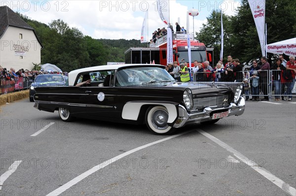Black and white luxury convertible classic car in front of a group of spectators, SOLITUDE REVIVAL