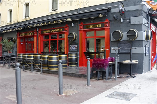 Marseille, Facade of an Irish pub with red colour and barrels in front of the entrance, Marseille,
