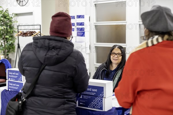Detroit, Michigan, A representative for DTE Energy hands out energy-saving LED light bulbs at a