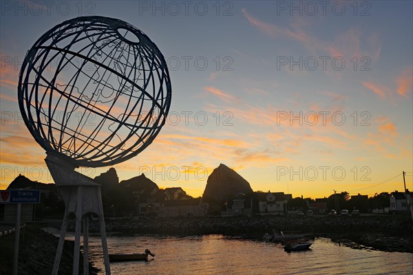 Large globe and small harbour in the evening light, Lovunden, Helgeland coast, Traena, Norway,