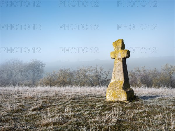 Medieval stone cross in hoarfrost and fog in winter, murder cross, atonement cross, Freyburg