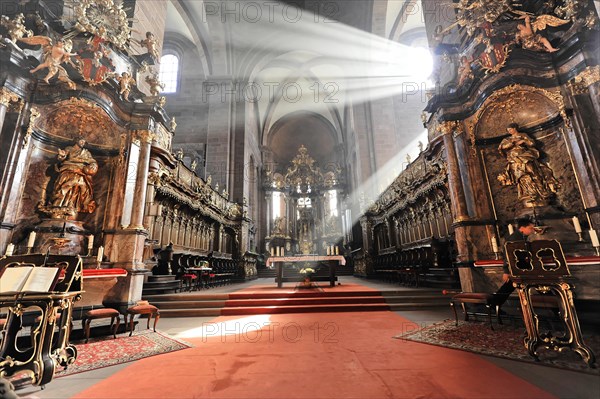 Speyer Cathedral, rays of light fall on the red carpet in a church with baroque sculptures, Speyer