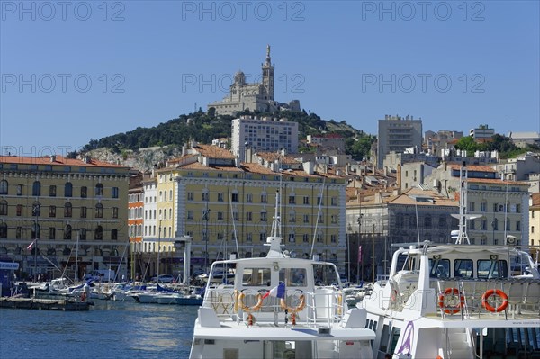 The old harbour, Vieux Port, behind the basilica Notre-Dame de la Garde, view of a harbour with