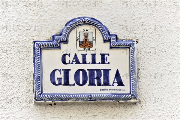 Solabrena, Ceramic street sign 'Calle Gloria' with blue and white lettering and ornaments,