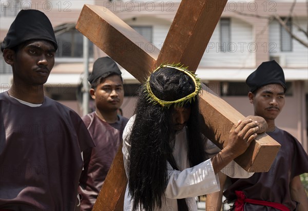 Christian devotees takes part in a perform to re-enactment of the crucifixion of Jesus Christ