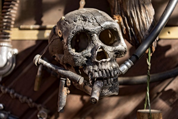 Old entrance door whimsically decorated, skull, engine parts, cartridge cases, tools, old town,
