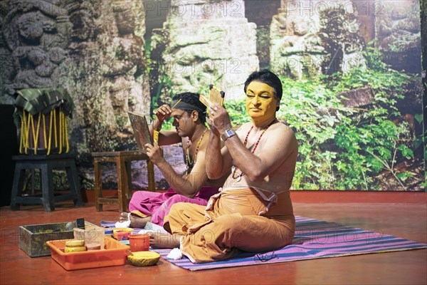 Kathakali performers or mime artists, 38 and 60 years old, make up their faces, Kochi Kathakali