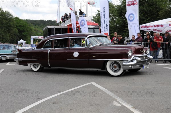 Burgundy red Cadillac classic car drives past a crowd at an event, SOLITUDE REVIVAL 2011,