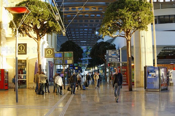Marseille-Saint-Charles railway station, Marseille, travellers in an illuminated station concourse