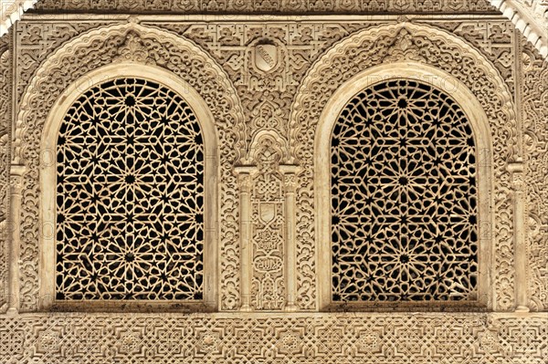 Artistic stone carvings, Alhambra, Granada, Two windows with ornate Islamic carvings in a stone