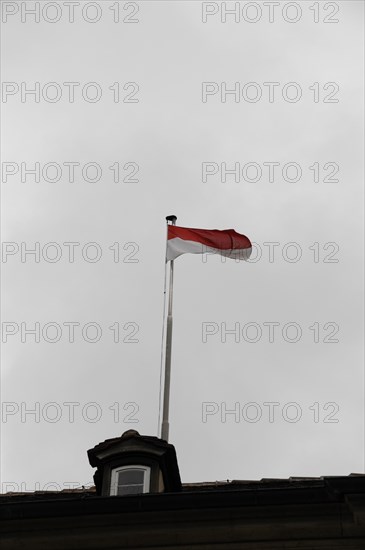 Langenburg Castle, A waving flag on a flagpole against a grey, cloudy sky, Langenburg Castle,