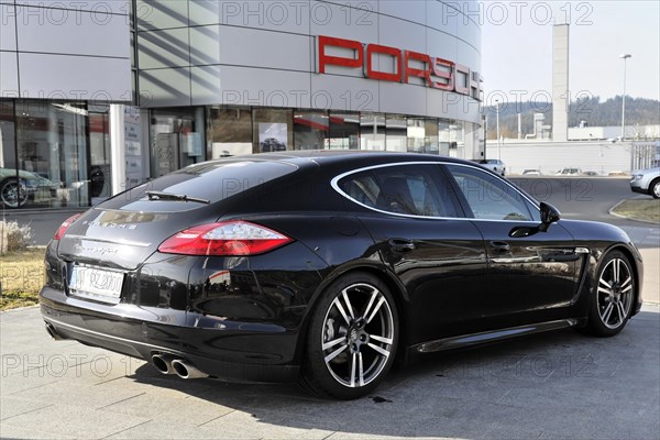 Side view of a black Porsche Panamera outside a car dealership, Schwaebisch Gmuend,