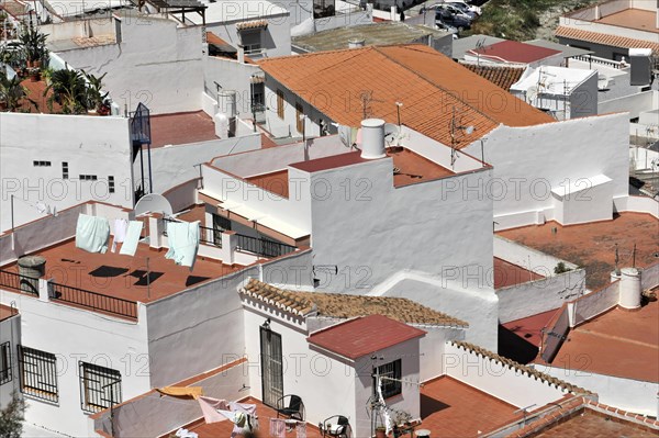 Solabrena, aerial view of a town with white buildings and terracotta roofs, laundry hanging
