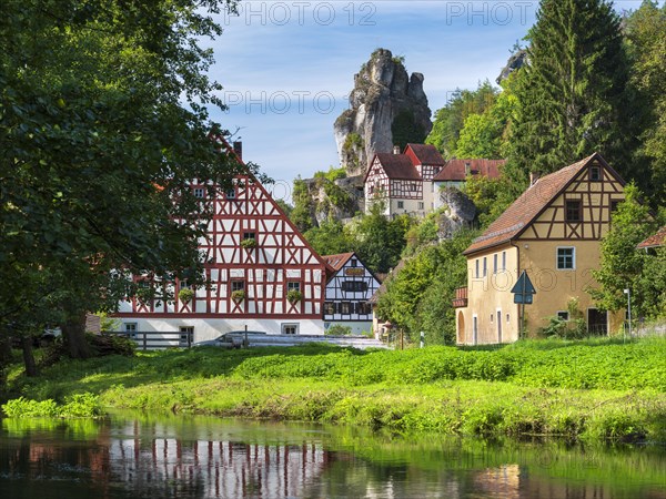 Zechenstein rock formation and half-timbered houses on the Puettlach river, rock castle and