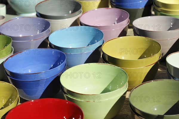 Pottery bowls, pots, colourful stacked clay bowls at an outdoor market, Marseille, Departement