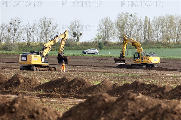 Excavators begin preparations for the construction site access road on the L 50 at the future Intel