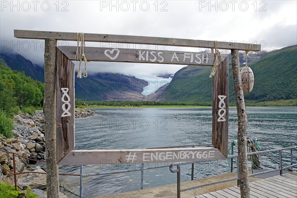 View of glacier tongue and lake through a wooden window, Svartisen, Kystriksveien, FV 17, Norway,