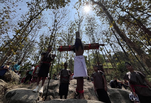 Christian devotees takes part in a perform to re-enactment of the crucifixion of Jesus Christ