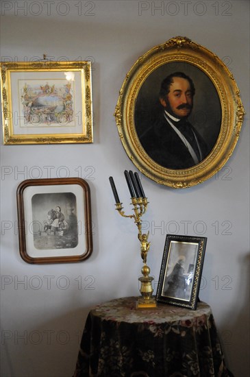 Langenburg Castle, wall with paintings, photos and candlesticks in historical style, Langenburg