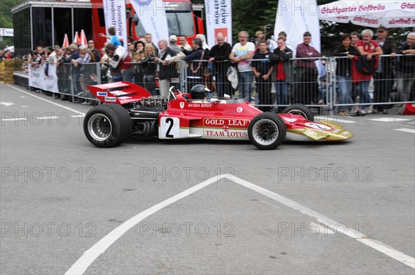 A red formula racing car from Gold Leaf Team Lotus bears the number 2, SOLITUDE REVIVAL 2011,