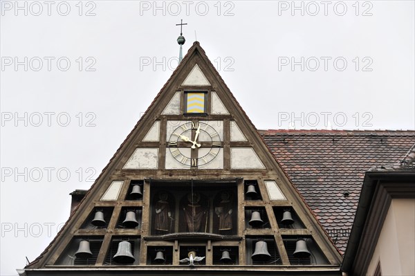 Wuerzburg, Gable of a building with clock and small carillon under a cloudy sky, Wuerzburg, Lower
