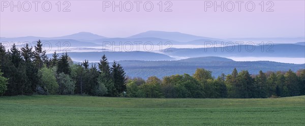 Panorama, view over endless chains of hills and forests at Gebaberg at dawn, fog in the valleys,