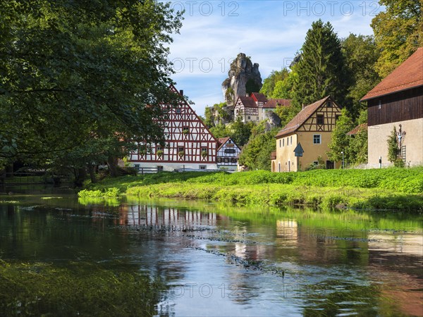 Zechenstein rock formation and half-timbered houses on the Puettlach river, rock castle and