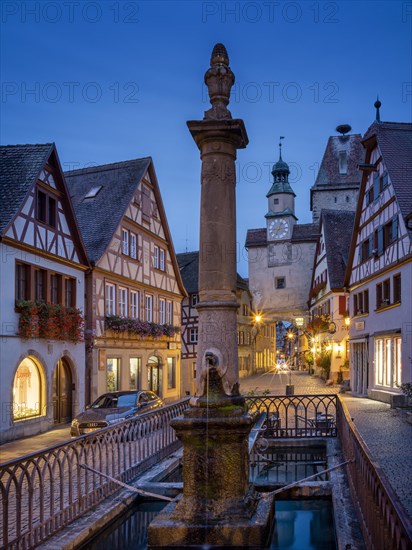 Roedergasse with Roederbrunnen, Markusturm and Roederbogen at dawn, Rothenburg ob der Tauber,