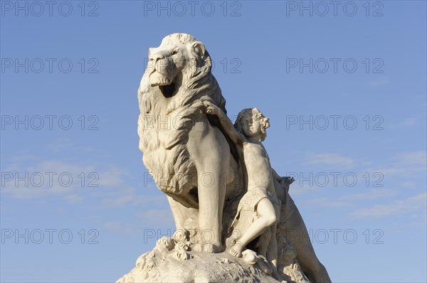 Marseille, White marble sculpture of a lion and a woman in front of a blue sky, Marseille,