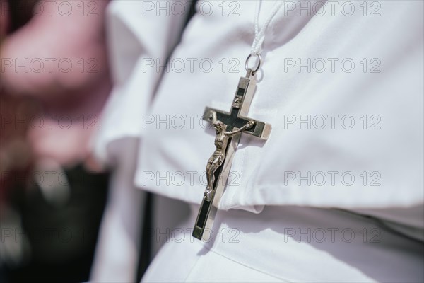 A nun wears a Cross as she recite prayers during a re-enactment of the crucifixion of Jesus Christ