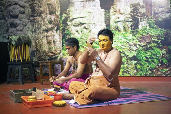 Kathakali performers or mime artists, 38 and 60 years old, make up their faces, Kochi Kathakali