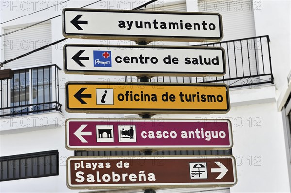 Several signposts with pictograms indicating different tourist destinations, Andalusia, Spain,
