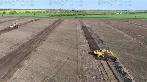Excavators begin preparations for the construction site access road on the L 50 at the future Intel
