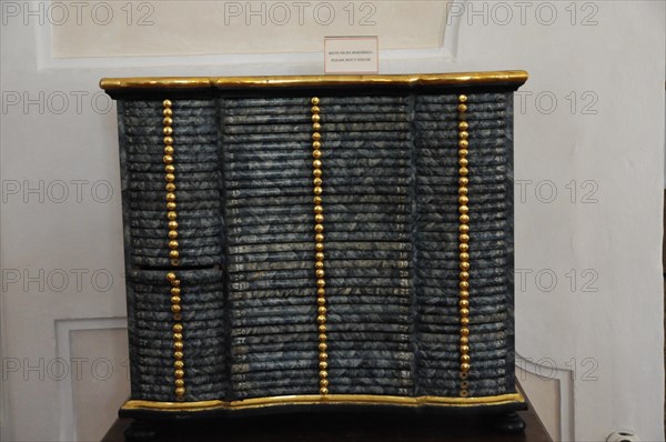 Langenburg Castle, Black antique chest of drawers with gold-coloured accents and textured surface,