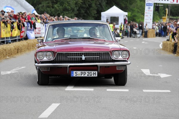Red convertible vintage car crossing the starting line of a car race, SOLITUDE REVIVAL 2011,
