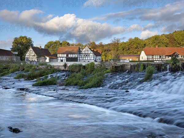Half-timbered houses on the Weisse Elster river with weir, Wuenschendorf (Elster), Thuringia,