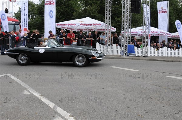 A black Jaguar E-Type classic car on the road with spectators in the background, SOLITUDE REVIVAL