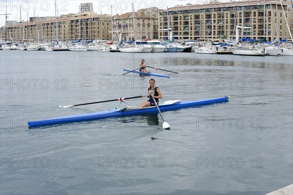 Marseille harbour, Two rowers in a rowing boat in a harbour area, Marseille, Departement