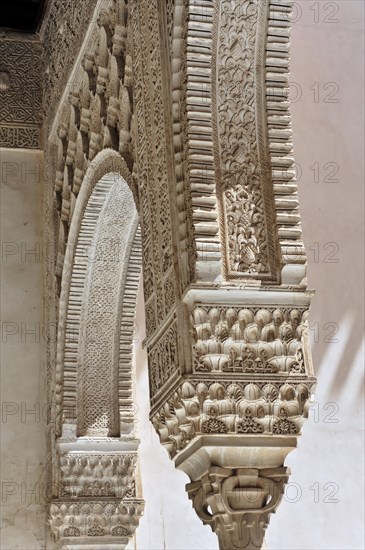 Artistic stone carvings, Alhambra, Granada, detail of an old Islamic building with fine stone