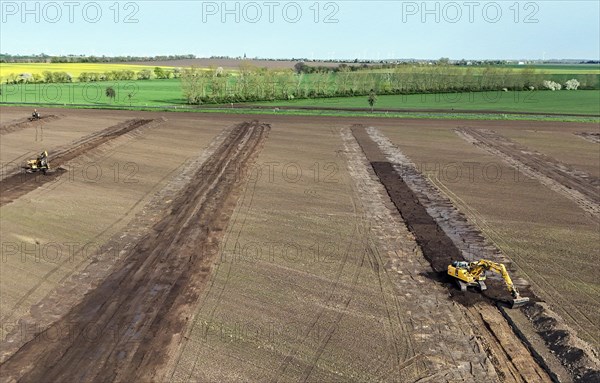 Excavators begin preparations for the construction site access road on the L 50 at the future Intel