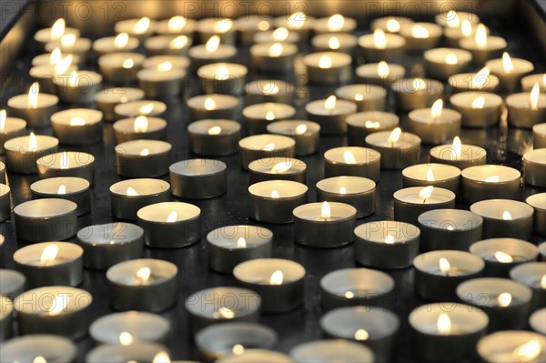 Speyer Cathedral, Many lit candles next to each other, radiating peace and contemplation, Speyer