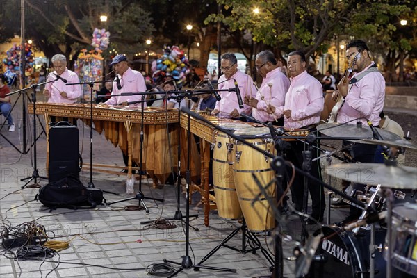 Oaxaca, Mexico, The Marimba del Estado band entertains a crowd in the zocalo. Marimba band music is