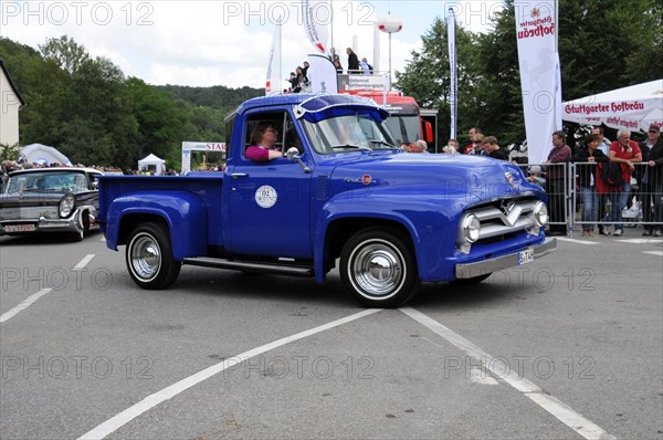 Blue Ford vintage pickup truck at an event with spectators at the roadside, SOLITUDE REVIVAL 2011,