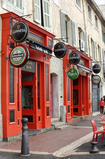 Marseille, Red facade of an Irish pub with outside tables on the pavement, Marseille, Departement