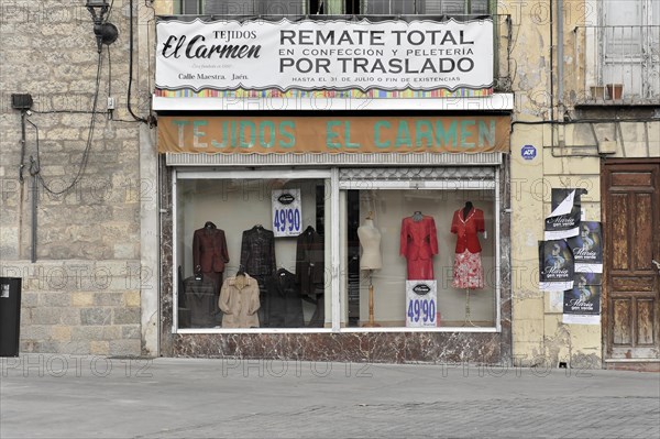 Jaen, Facade of a textile shop with shop window and advertisement for a sale, Jaen, Andalusia,