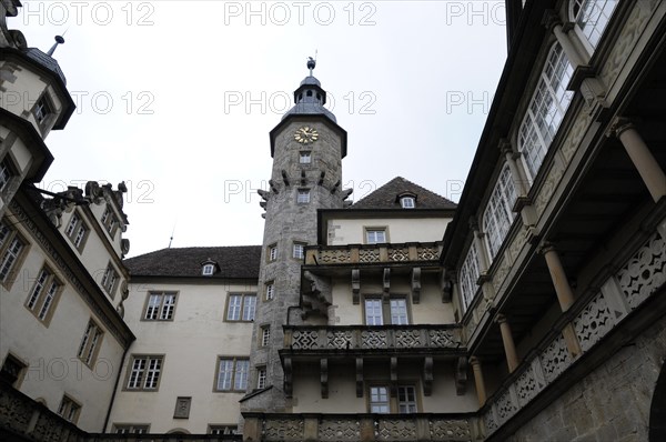 Langenburg Castle, A view of a castle with a tower and half-timbered elements under a grey sky,